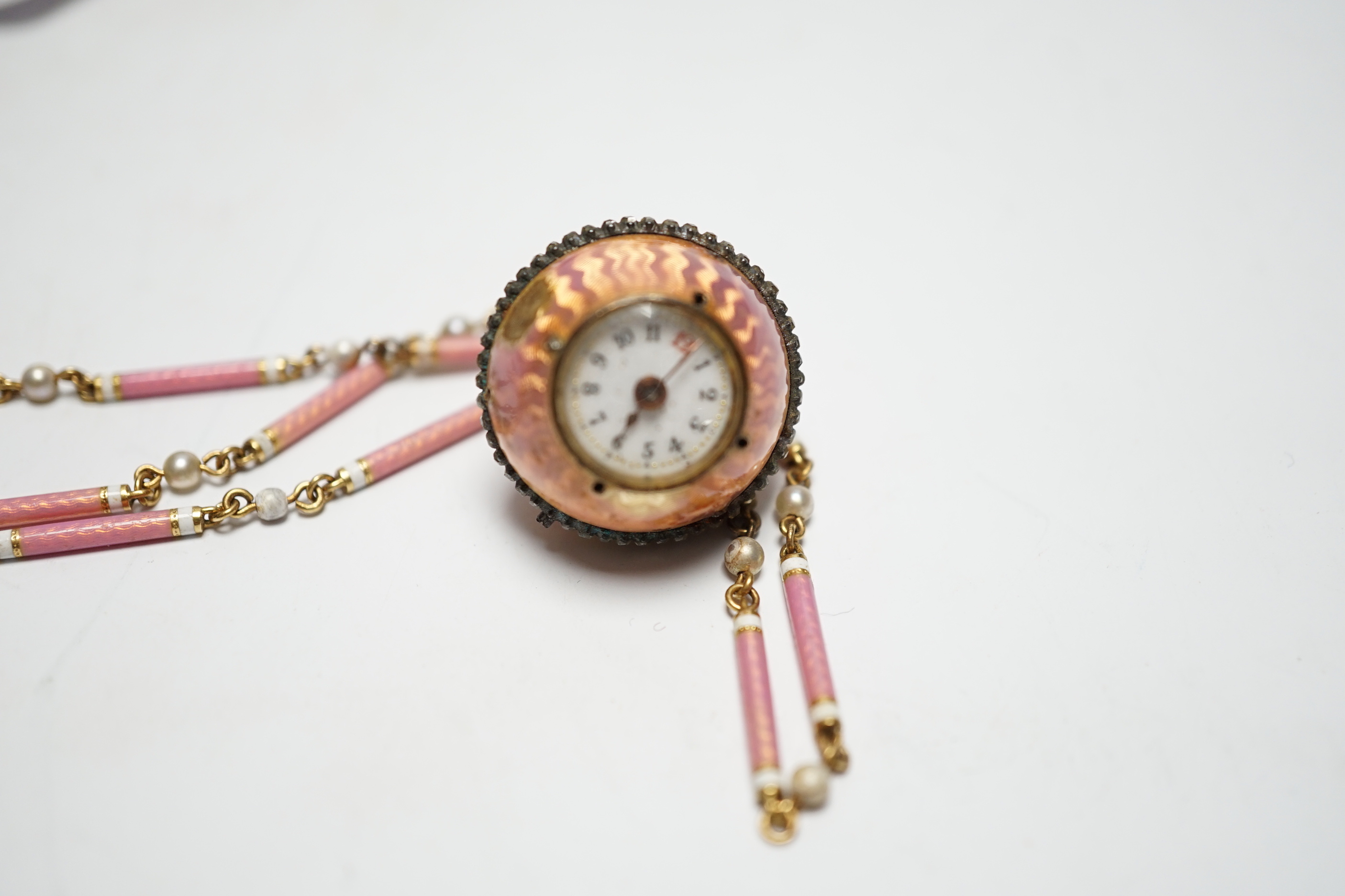 A lady's Swiss Belle Epoque yellow metal, rose cut diamond and enamelled globe watch, on a similar yellow metal rose cut diamond, two colour enamel and seed pearl set necklace, overall 84cm (a.f.).